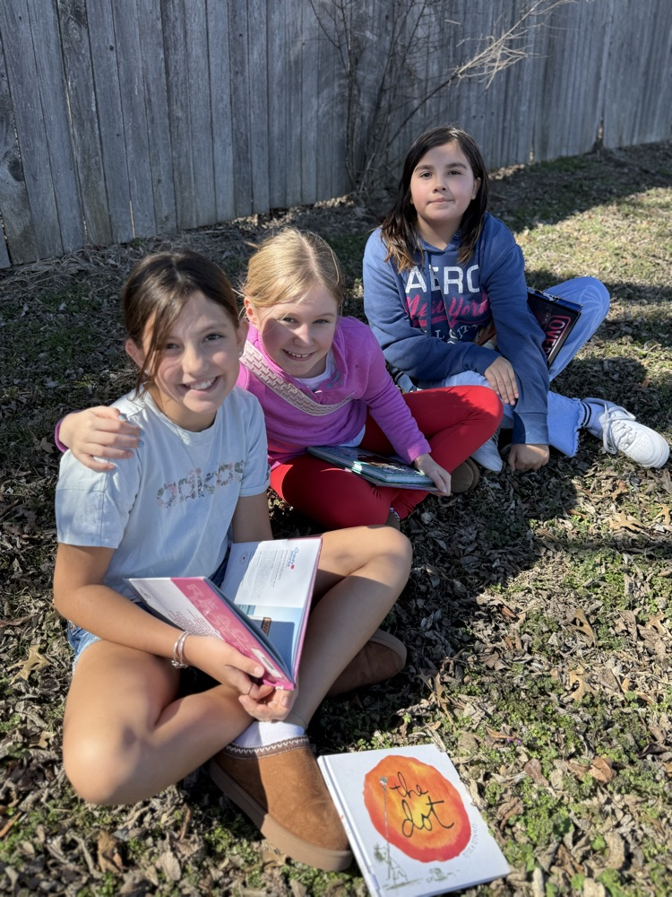 students reading in sunshine