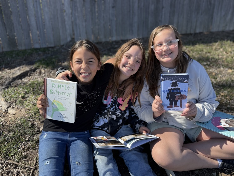 students reading in sunshine