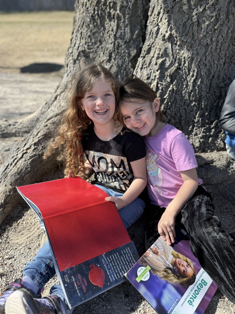 students reading in sunshine