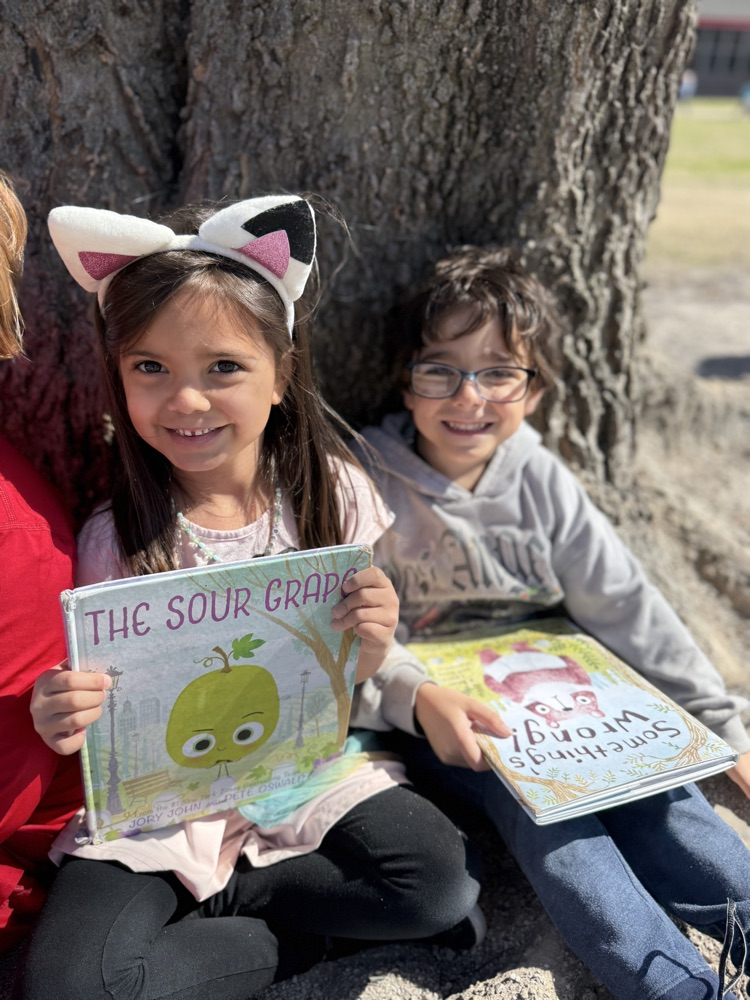 students reading in sunshine