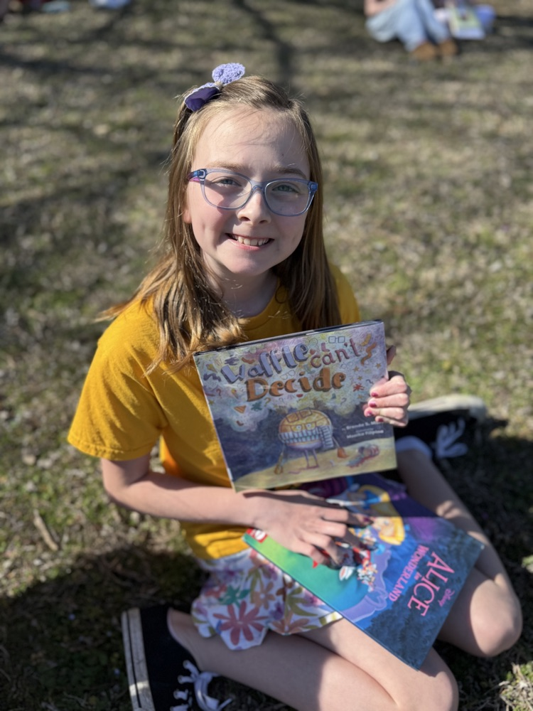 students reading in sunshine