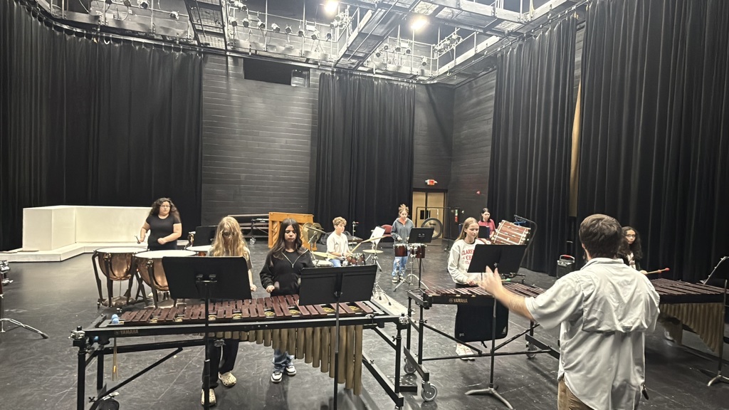 7th and 8th graders in a percussion ensemble playing for a judge