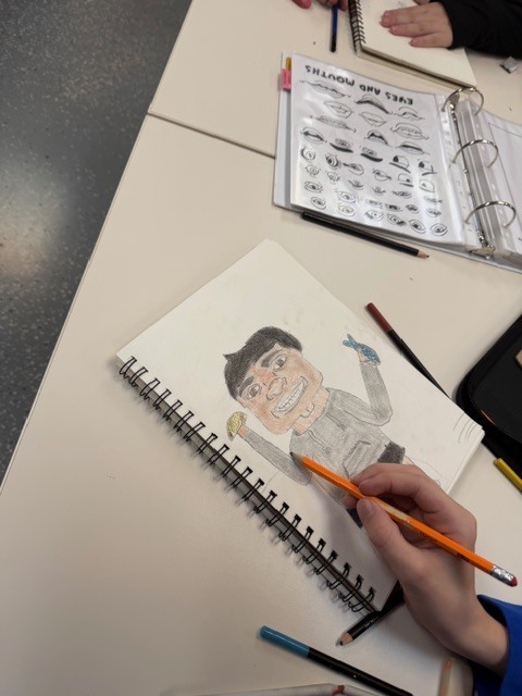Student drawing a caricature in art class. 