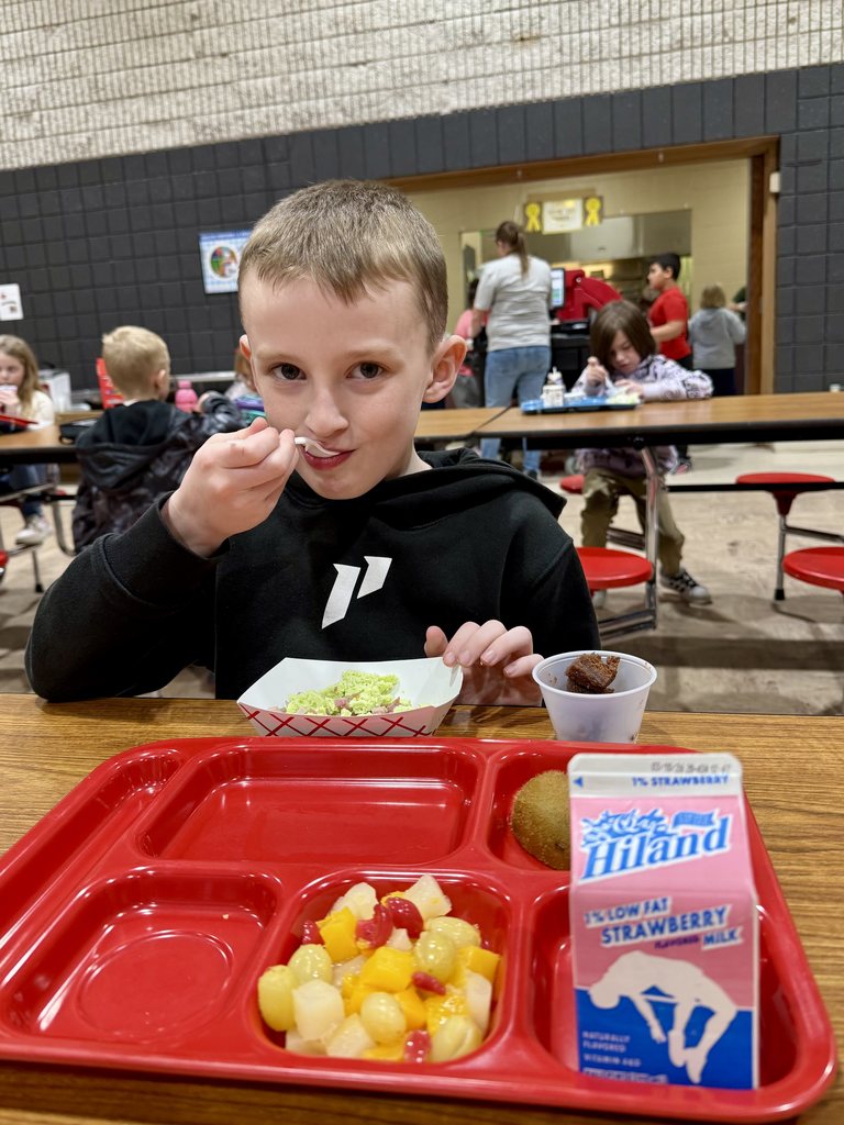 Student eating green eggs and hamv