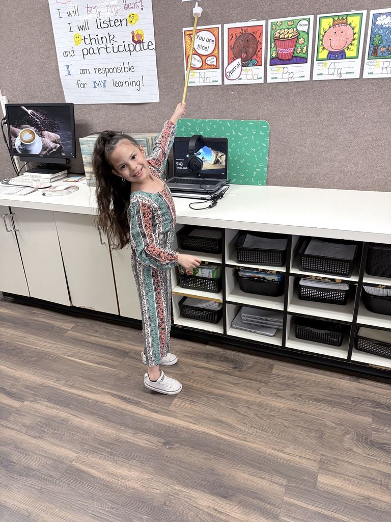 student dressed and acting as teacher