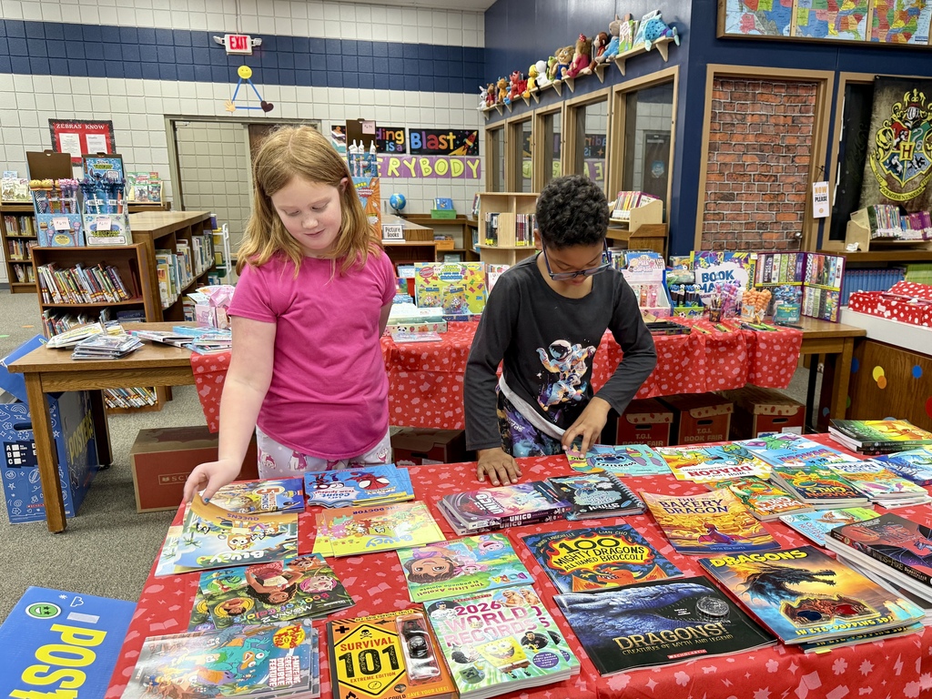 students looking at books