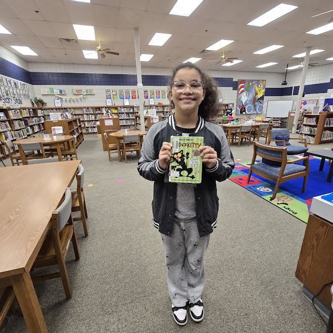 student holding winning book