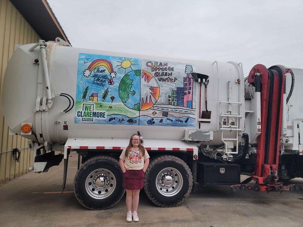 Addi with the trash truck with her artwork on it.
