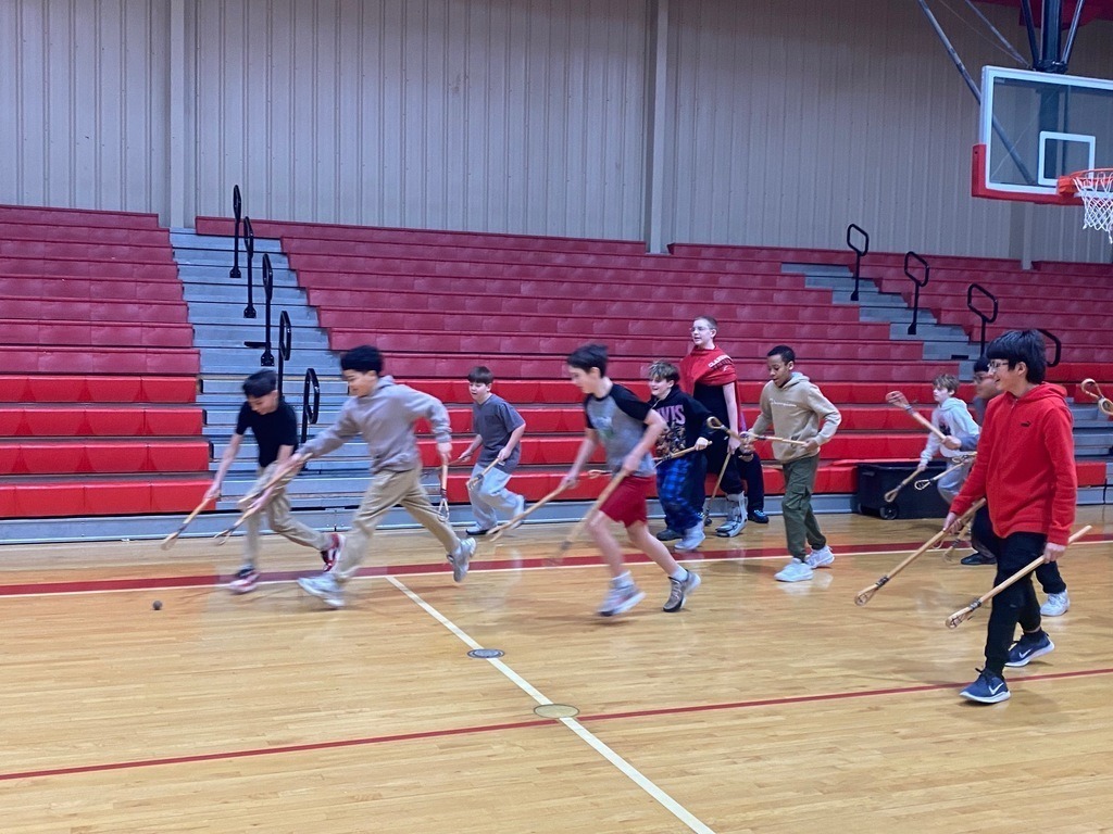 Junior high students learning and playing native american games.