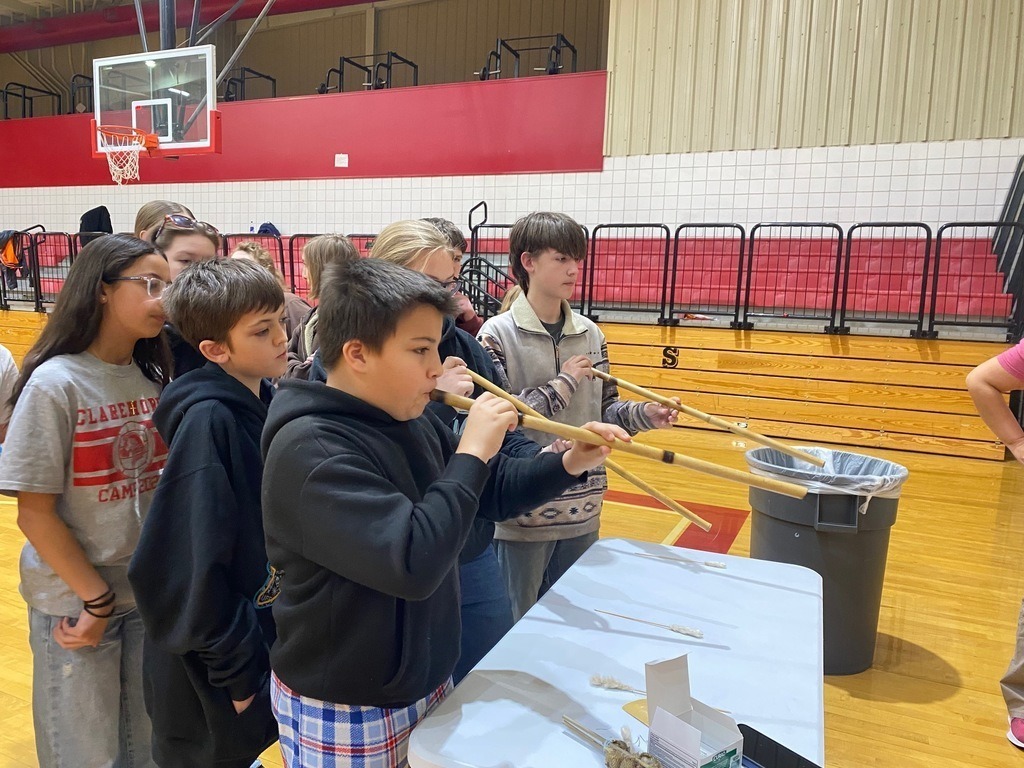 Junior high students learning and playing native american games.