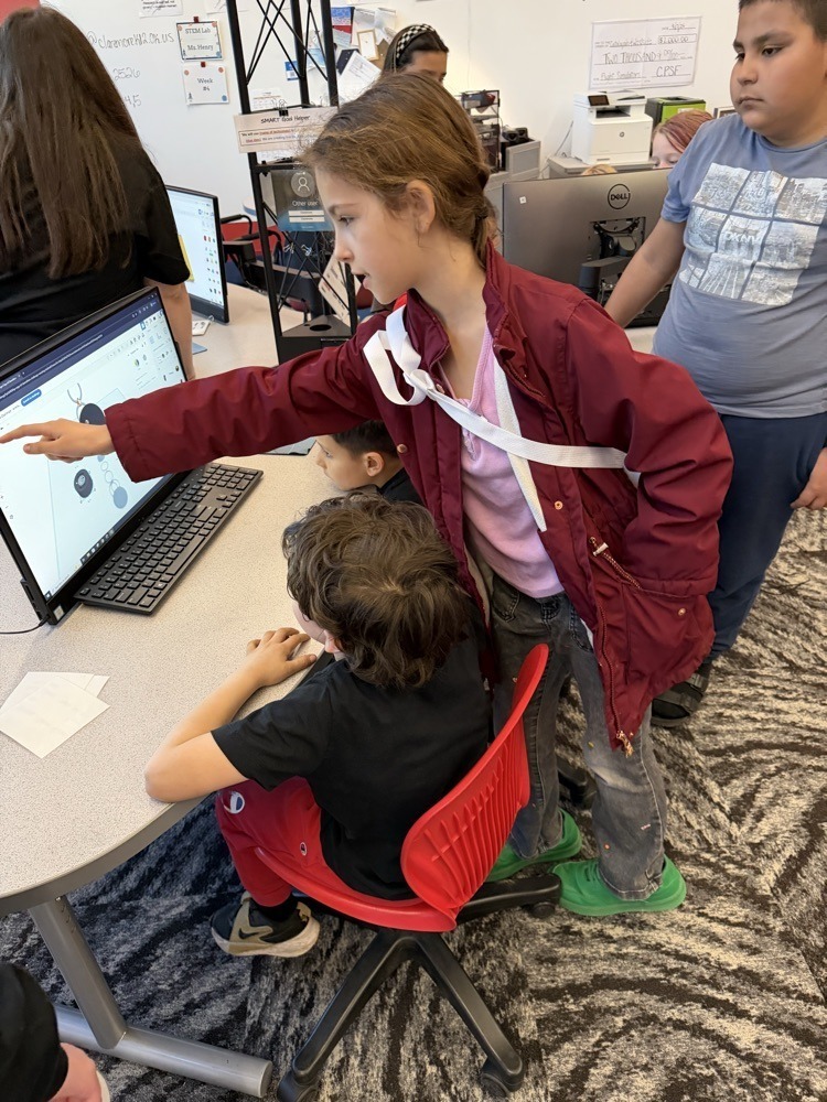Fourth Graders working with First Graders on stem projects.