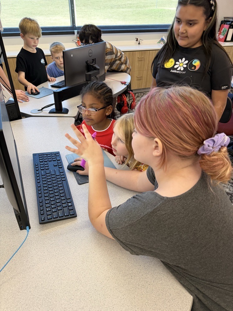 Fourth Graders working with First Graders on stem projects.