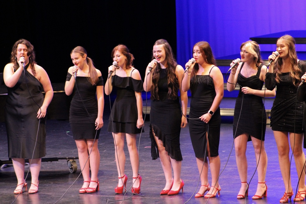 Students on stage singing at the RPAC