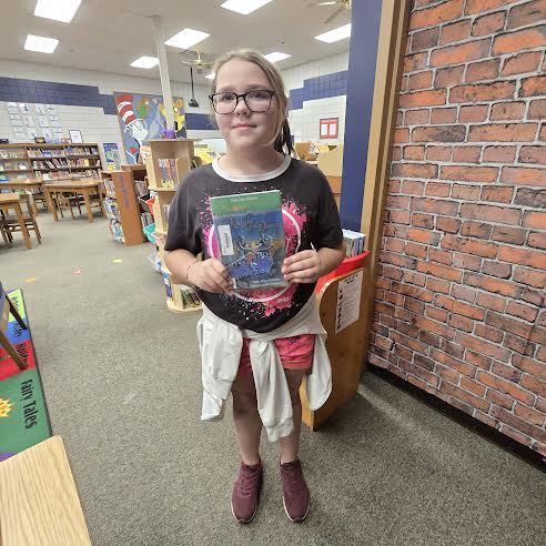 student holding book