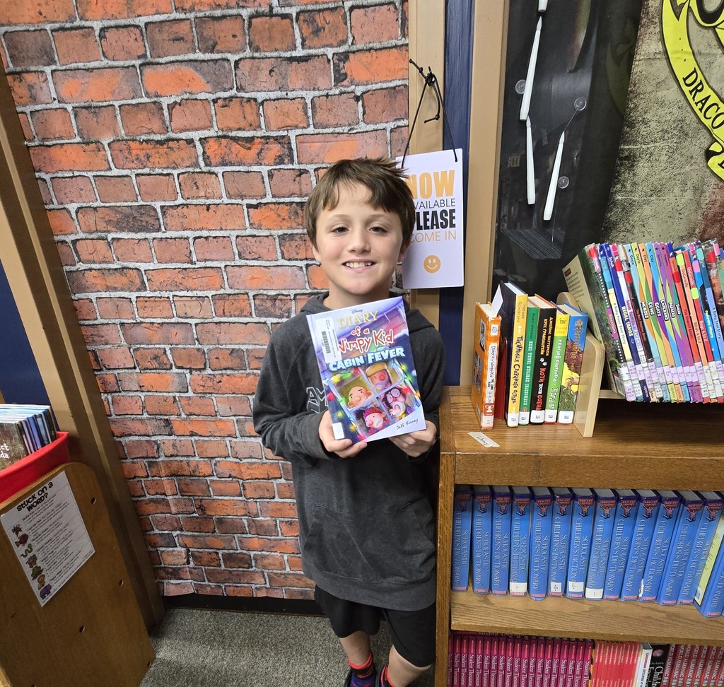 student holding book