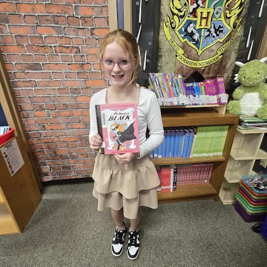 student holding book