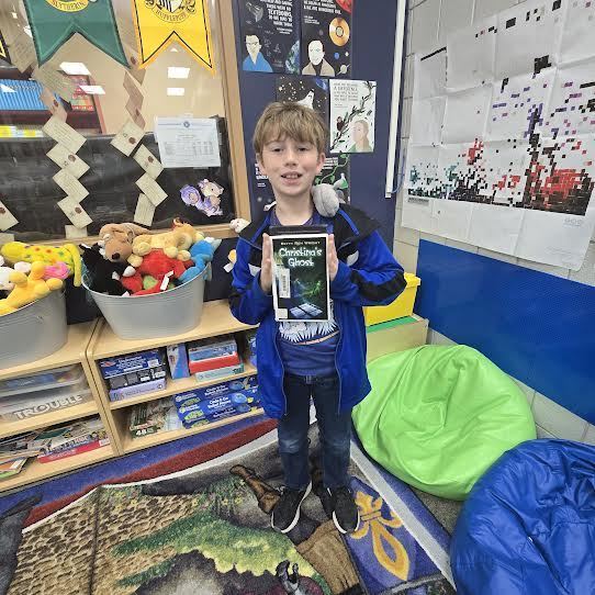 student holding book