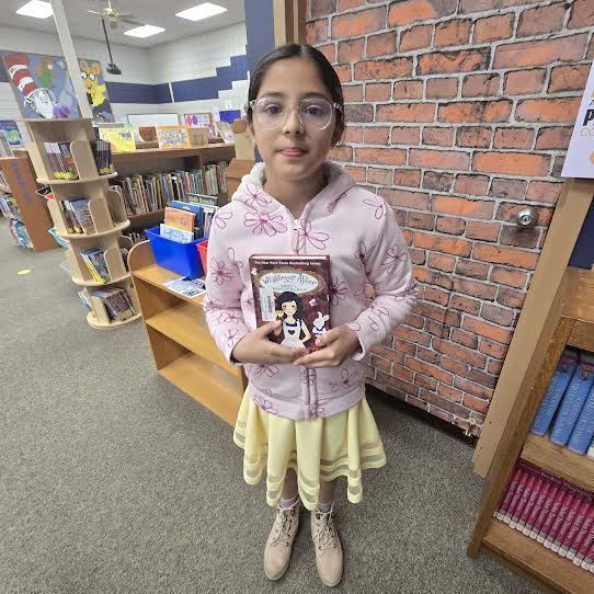 student holding book
