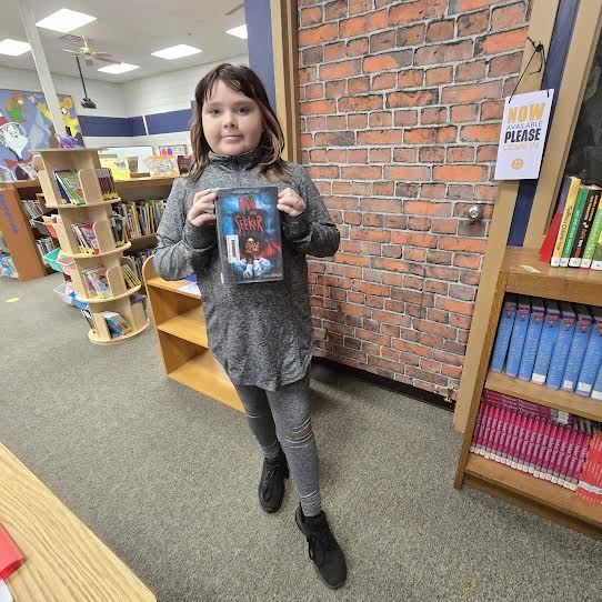 student holding book