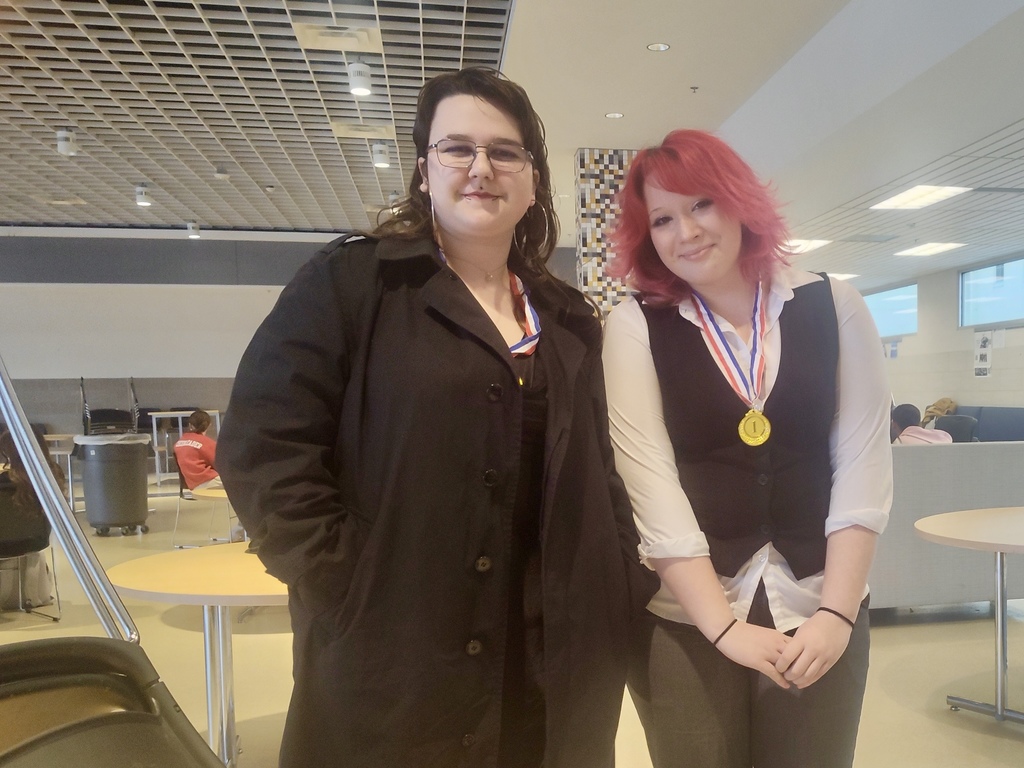 Students smiling after winning at debate contest