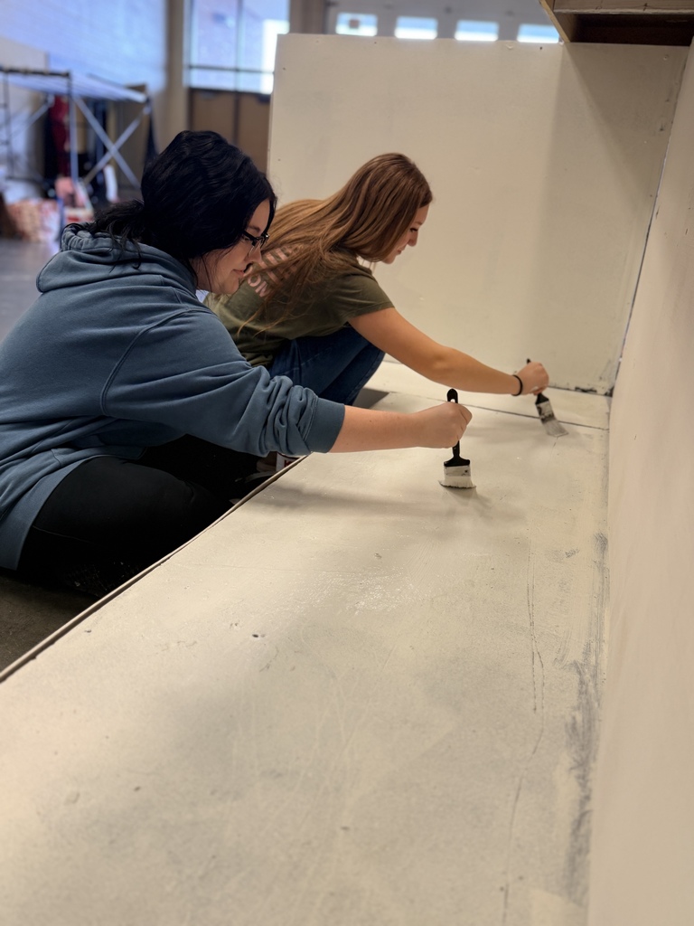 Students painting in the theatre production class