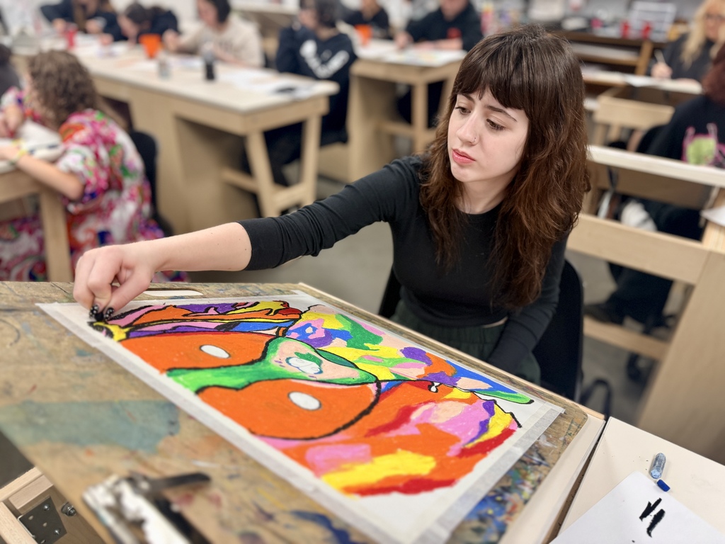 Student painting in art class