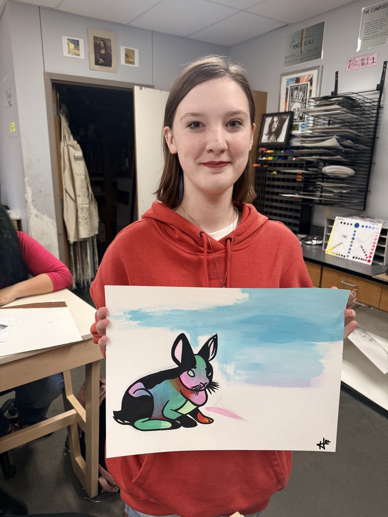 Student smiling with her art work