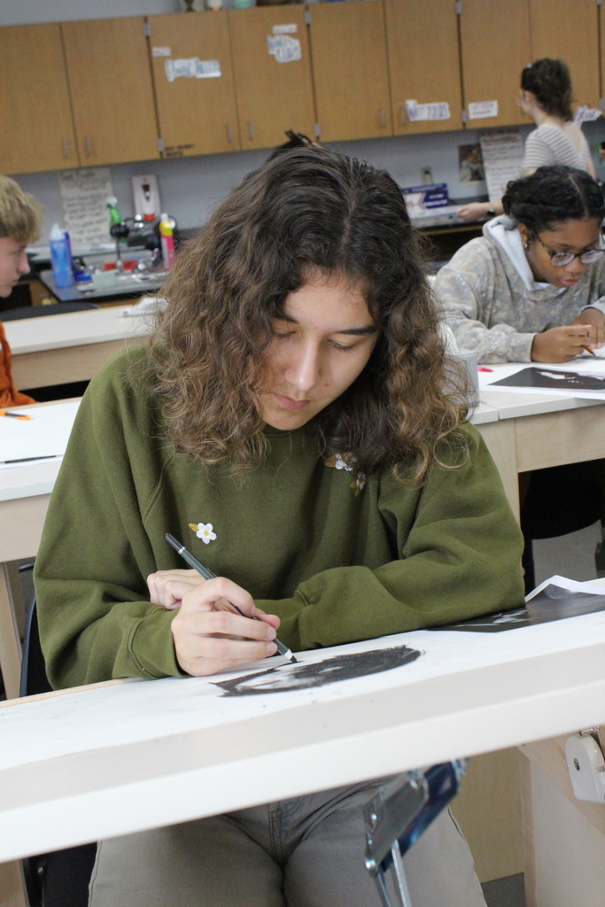 Student working hard on her art work in class