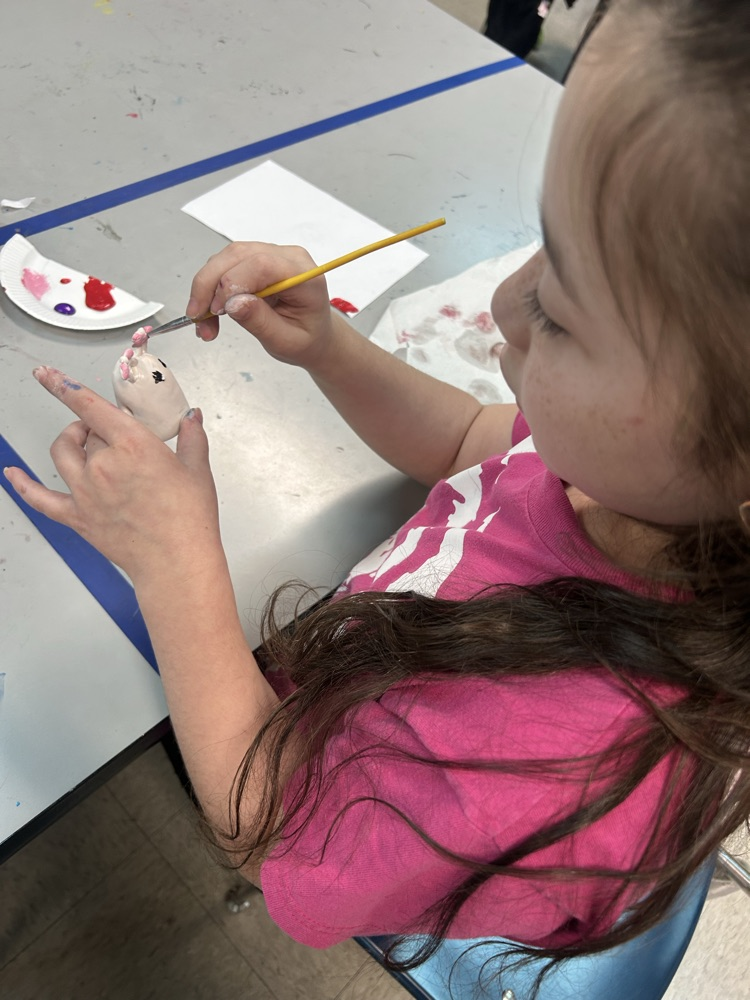 Student painting her clay project