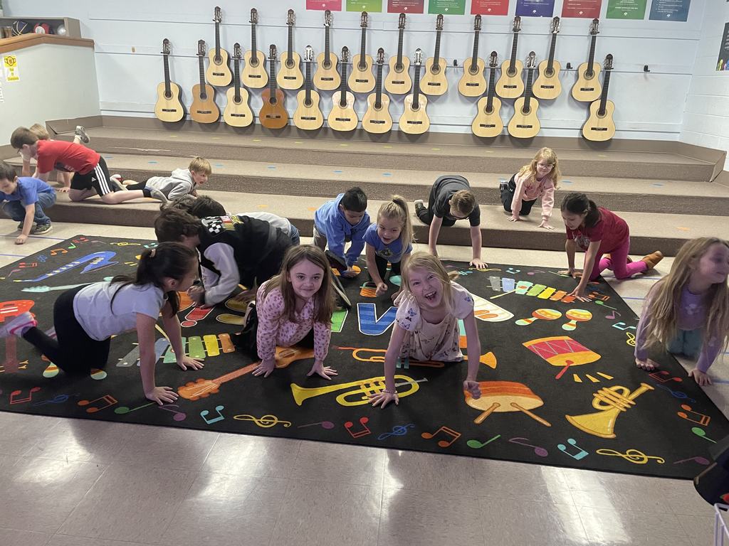 Students smiling and acting out tempo's in class