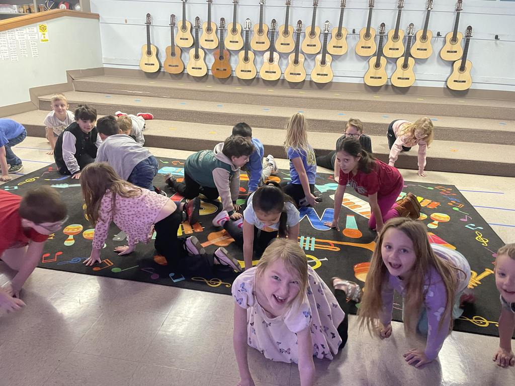Students crawling around on the floor while learning about tempo