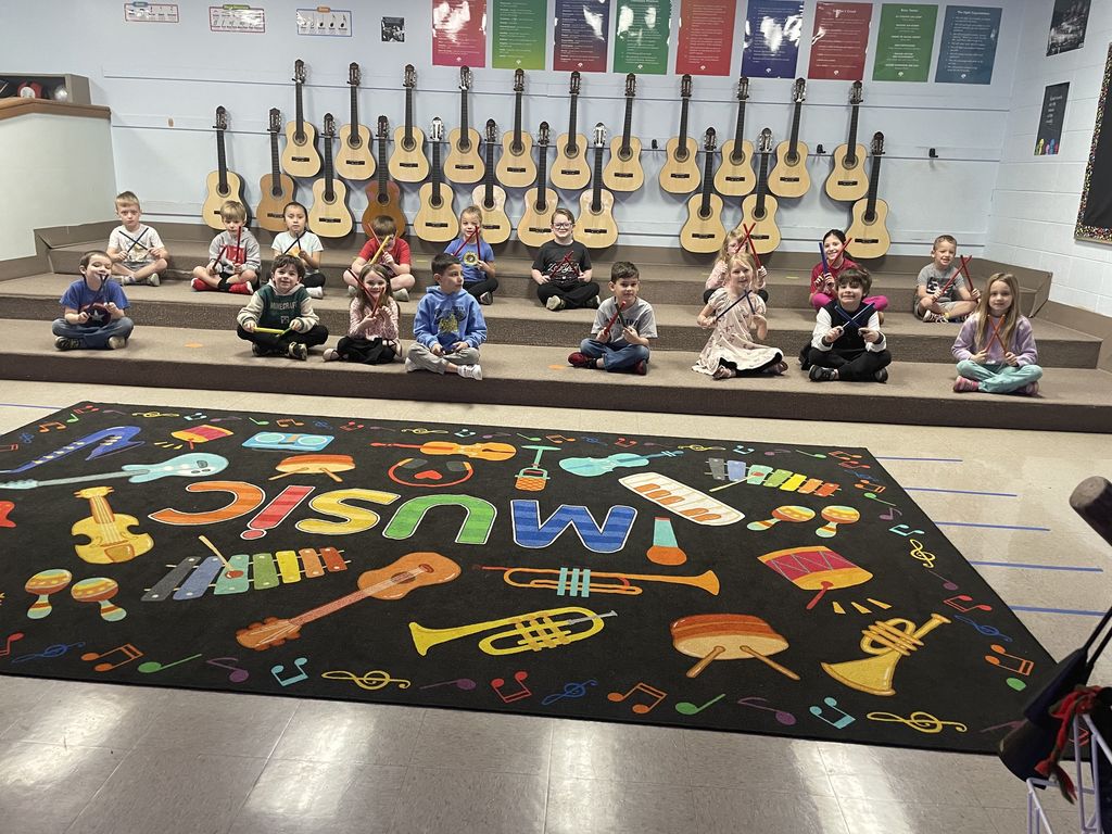 Students smiling while they work on tempo in music class