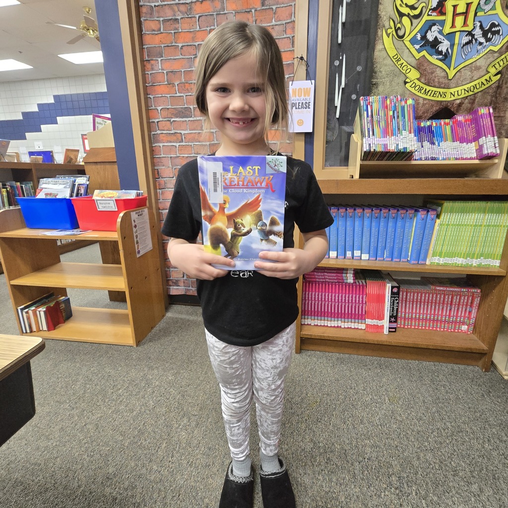 student holding book