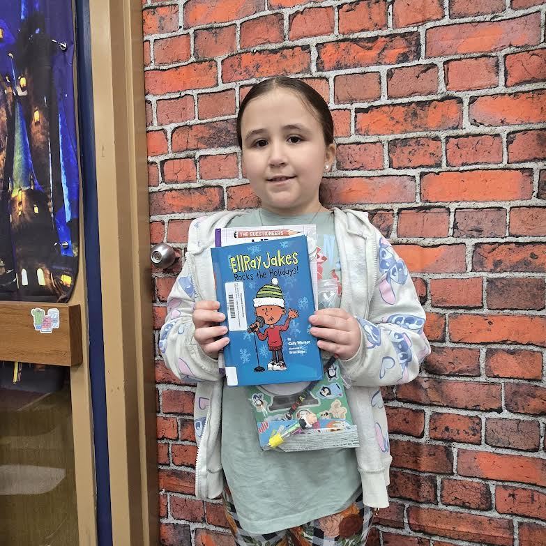 student holding book