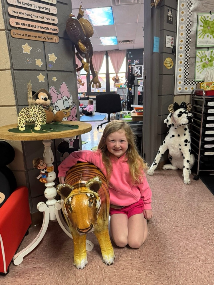 student posing with tiger 