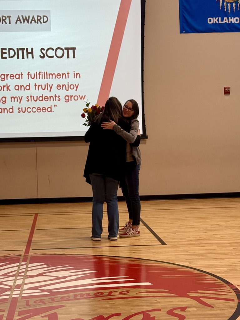 pillar of support winner hugging another staff member