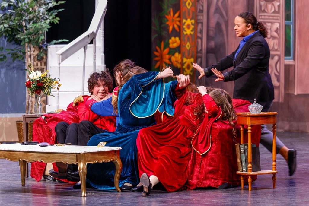Students acting on stage during their play,