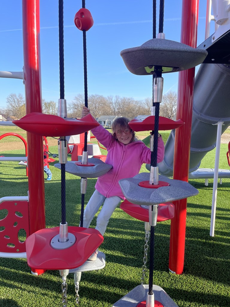 student playing on new playground