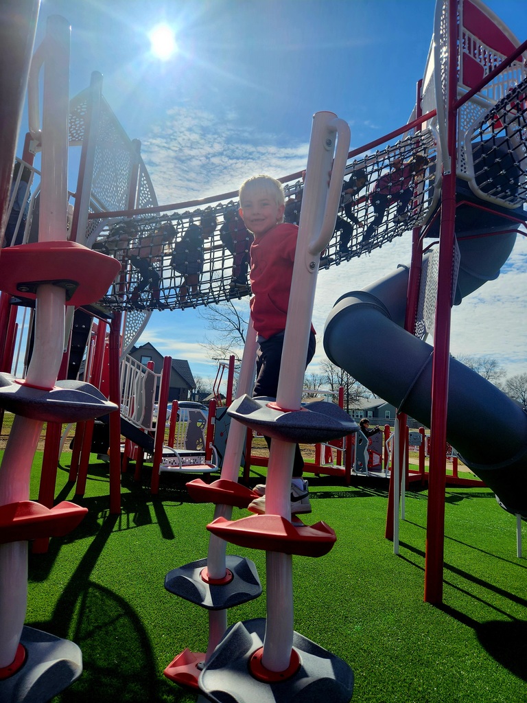student playing on new playground