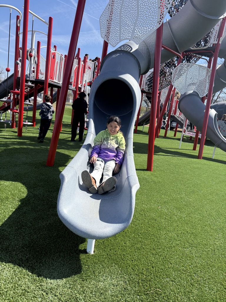 student playing on new playground