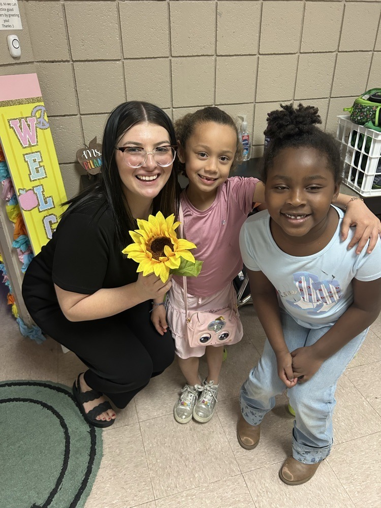 students gifting their teacher a flower