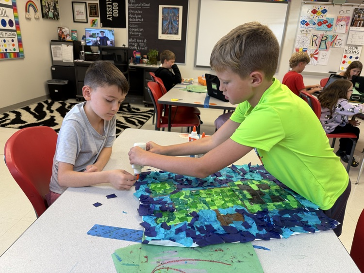 Students working together on a colorful art project in art class