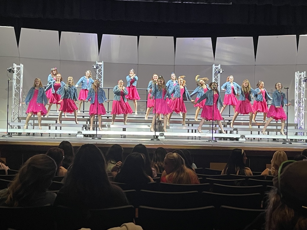 Sound Express on stage in their Jean jackets and pink dresses for contest