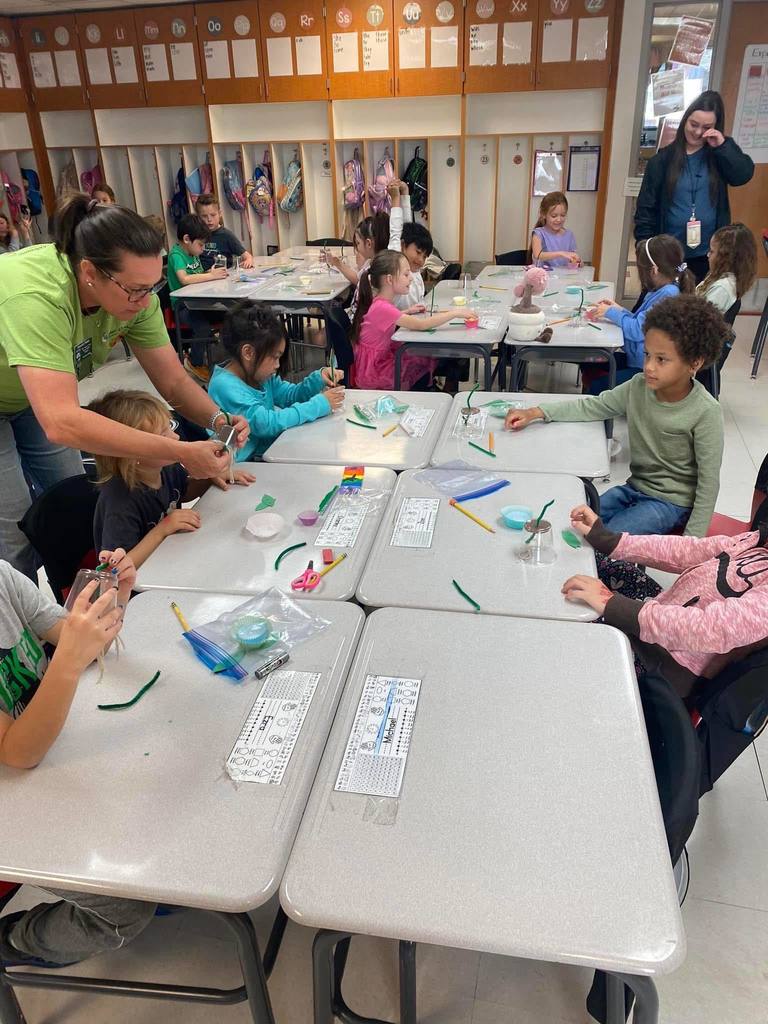 elementary students learning about gardening.