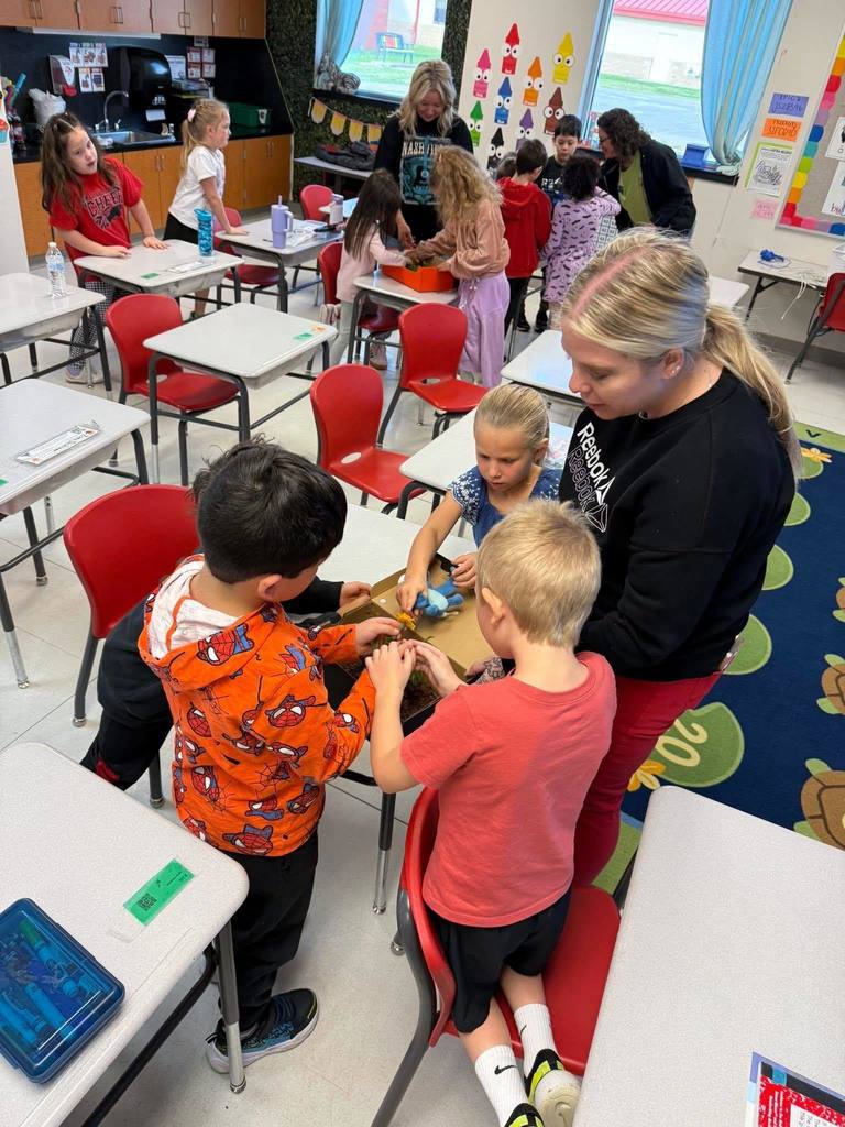 elementary students learning about gardening.