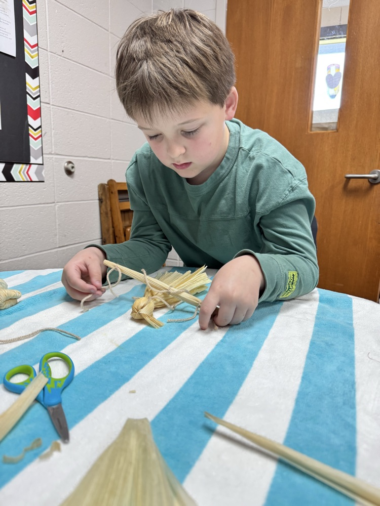 student making corn husks