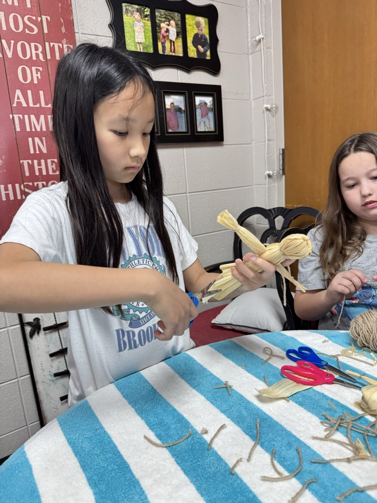 student making corn husks