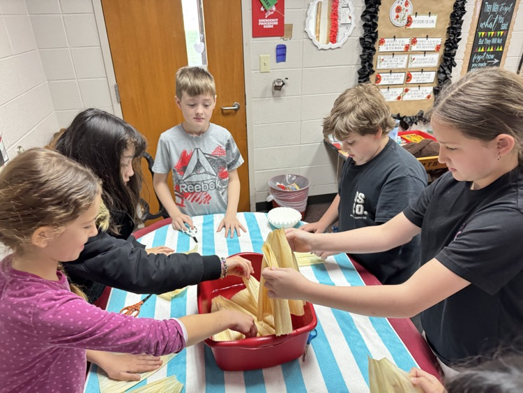 student making corn husks