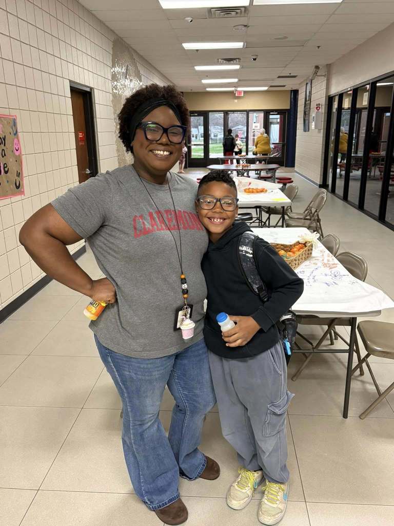 student and staff member smiling