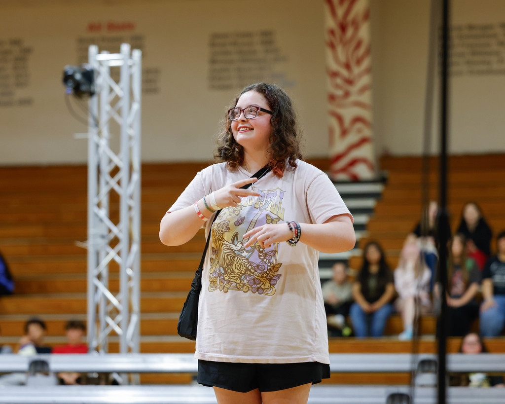 student doing a song in american sign langauge